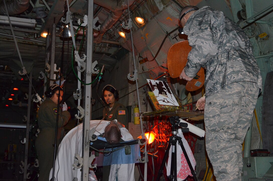 Maj. Warren Neary, an Air Force Space Command Individual Mobilization Augmentee and historian, paints a color/values study of Capt. Adriana Valadez (right) and SSgt Amanda Pena, both from the  433rd Aeromedical Squadron, Joint Base San Antonio-Lackland Texas. Valadez was acknowledged by Chief of Staff of the Air Force, Gen. Mark A. Welsh, III, when he told the AFA’s audience of her extraordinary heroism.(U.S. Air Force photo/1st. Lt. Cresencio Medina) 
