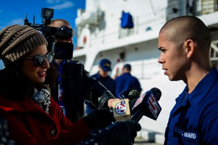Seaman Julian Cubides, USCGC Gallatin (WHEC 721) law enforcement member, is interviewed by local Charleston, S.C., news teams after he returned from a three-month deployment. Gallatin’s crew seized more than 1,000 kilos of cocaine with a street value of $34 million during the ship’s final patrol. (U.S. Air Force photo/ Senior Airman Dennis Sloan)