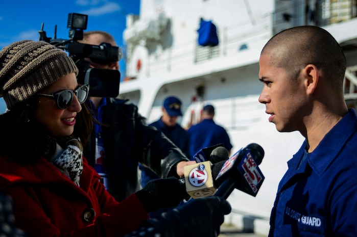 Seaman Julian Cubides, USCGC Gallatin (WHEC 721) law enforcement member, is interviewed by local Charleston, S.C., news teams after he returned from a three-month deployment. Gallatin’s crew seized more than 1,000 kilos of cocaine with a street value of $34 million during the ship’s final patrol. (U.S. Air Force photo/ Senior Airman Dennis Sloan)