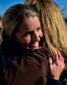 A Coastguardsman hugs her mother after returning from a three-month deployment on the USCGC Gallatin (WHEC 721), which returned from its final patrol Dec. 11, 2013, in Charleston, S.C. Gallatin’s crew seized more than 1,000 kilos of cocaine with a street value of $34 million. (U.S. Air Force photo/ Senior Airman Dennis Sloan)