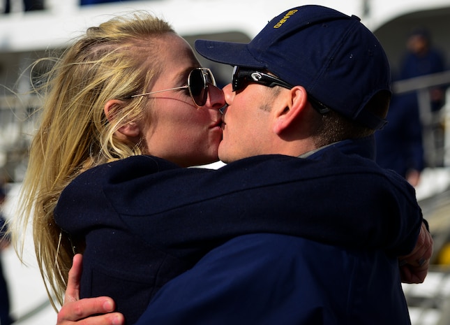 Petty Officer Dustin Reed, USCGC Gallatin (WHEC 721) boatswain’s mate, kisses his girlfriend Staci Ulichnie, after he returned from a three-month deployment Dec. 11, 2013, in Charleston, S.C. During the final patrol, Gallatin’s crew seized more than 1,000 kilos of cocaine with a street value of $34 million. (U.S. Air Force photo/ Senior Airman Dennis Sloan)