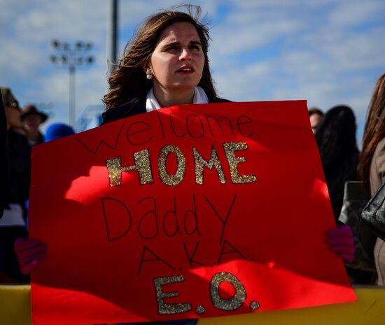 Catherine Fulenwider holds a sign for her father, Lt. Cmdr. Geoff Fulenwider, USCGC Gallatin’s engineering officer, as he returns home from a three-month deployment to the Caribbean, Dec. 11, 2013. The Gallatin returned to Charleston, S.C. after completing its final patrol and will be decommissioned next year before being transferred to the Nigerian Navy. (U.S. Air Force photo/Senior Airman Dennis Sloan)