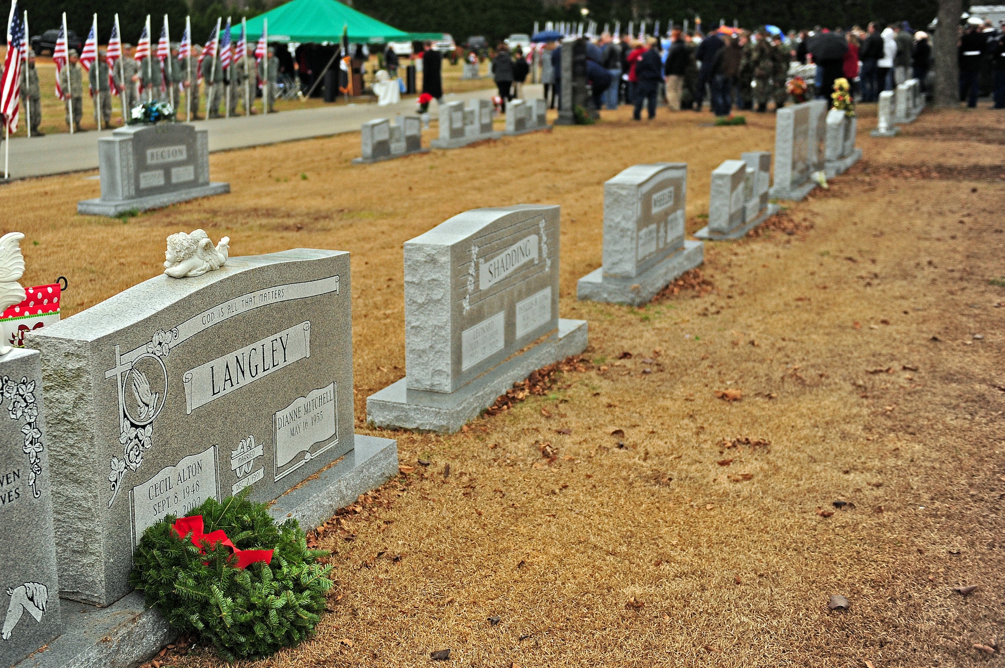 Event patrons gather at the end of a wreath-laying ceremony at Evergreen Memorial Cemetery, Goldsboro, N.C., Dec. 14, 2013.  The ceremony closed with the playing of taps and the retiring of the colors by the Seymour Johnson Air Force Base Honor Guard.  The event was part of the Wreaths Across America mission, which delivered more than 540,000 remembrance wreaths to 908 cemeteries across the country in honor of our nation’s veterans.  (U.S. Air Force photo by Airman 1st Class Brittain Crolley)