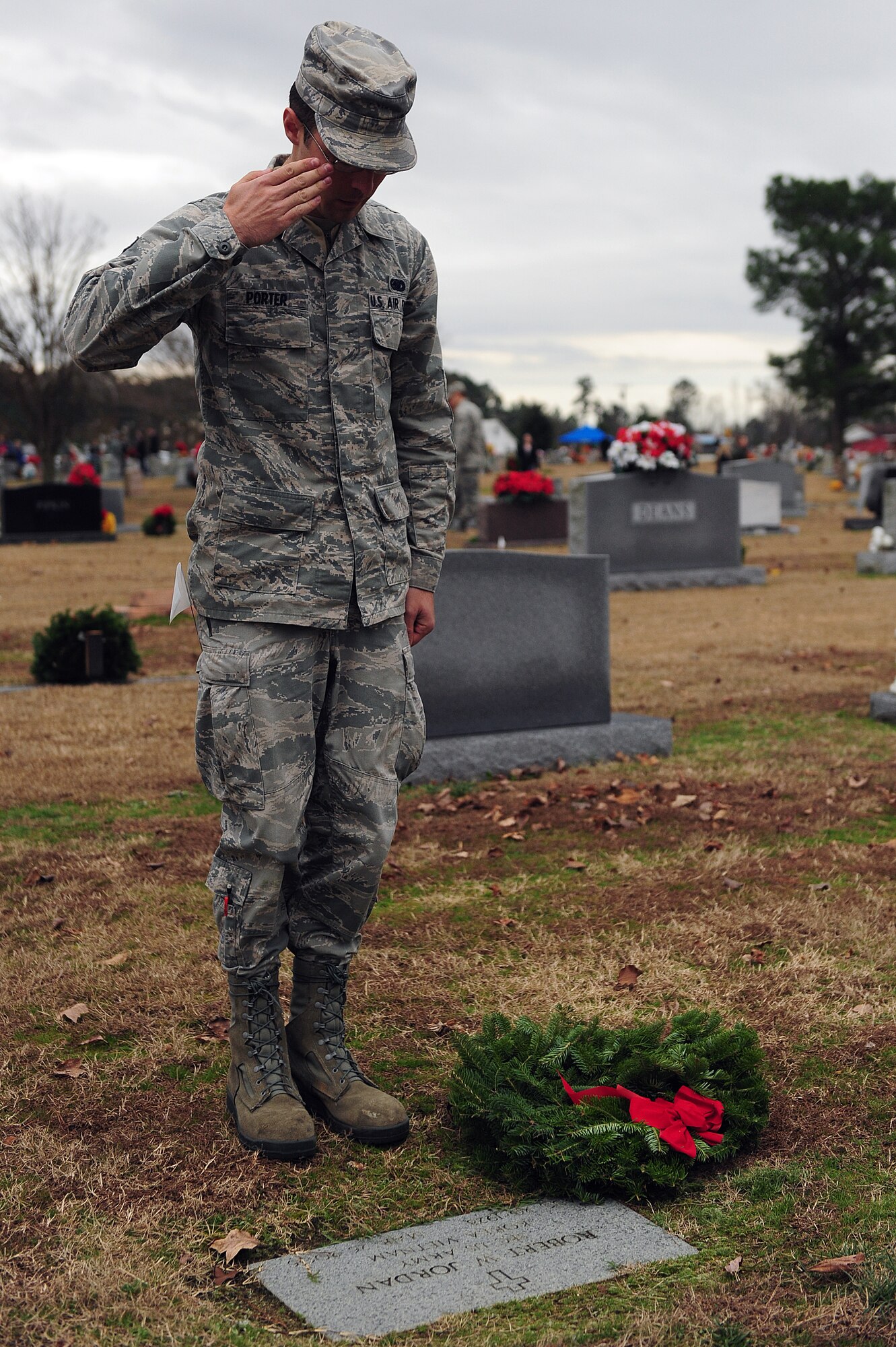 Senior Airman Corey Porter, 4th Logistics Readiness Squadron fuels management technician, salutes the grave of a Vietnam veteran during a wreath-laying ceremony at Evergreen Memorial Cemetery, Goldsboro, N.C., Dec. 14, 2013.  More than 100 Airmen from Seymour Johnson Air Force Base, N.C., volunteered at the event to hand out and lay wreaths on graves of our nation’s veterans.  The event was part of the Wreaths Across America mission, which delivered more than 540,000 remembrance wreaths to 908 cemeteries across the country in honor of our nation’s veterans.  (U.S. Air Force photo by Airman 1st Class Brittain Crolley)