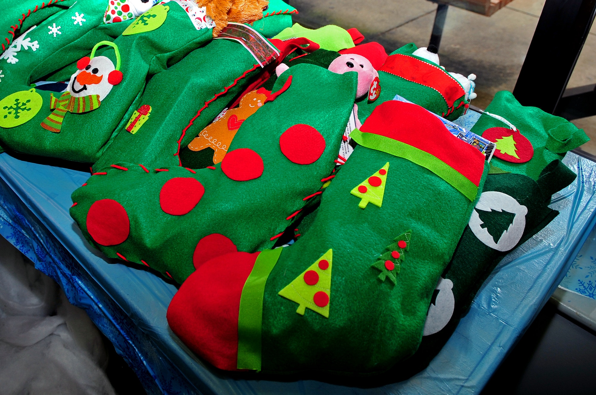 Handmade stockings, donated by high school students from Raleigh, N.C., sit on display during the Breakfast with Santa event at Seymour Johnson Air Force Base, N.C., Dec. 14, 2013.  Allan Pedersen, USO base liaison, gave the stockings to children while they were photographed with Santa Claus.  (U.S. Air Force photo by Airman 1st Class Shawna Keyes)