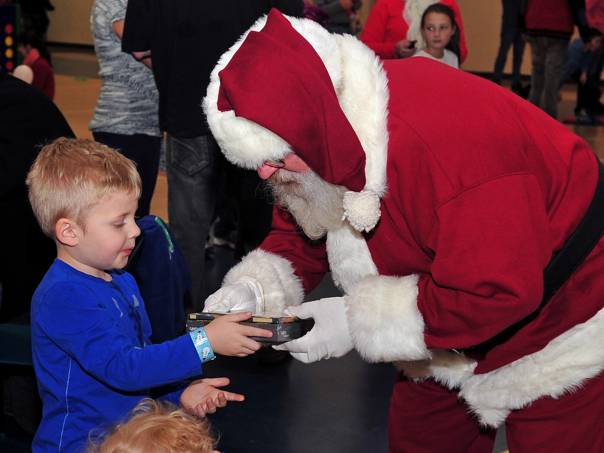 A member of Team Seymour shows Santa Claus a gift he received during the Breakfast with Santa event at Seymour Johnson Air Force Base, N.C., Dec. 14, 2013.  The Top 3, a private organization dedicated to establishing a cohesive group of senior non-commissioned officers, organized the event to spread holiday cheer.  (U.S. Air Force photo by Airman 1st Class Shawna Keyes)