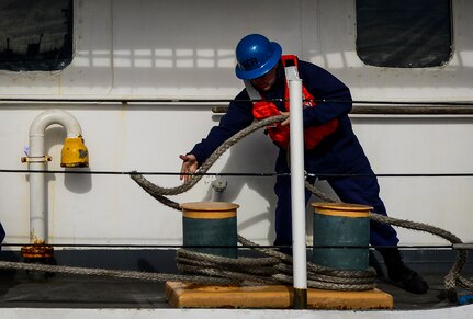 A USCGC Gallatin (WHEC 721) Coastguardsman secures a line after the ship moored Dec. 11, 2013, in Charleston, S.C. Gallatin’s crew seized more than 1,000 kilos of cocaine with a street value of $34 million during the ship’s final patrol. (U.S. Air Force photo/ Senior Airman Dennis Sloan)