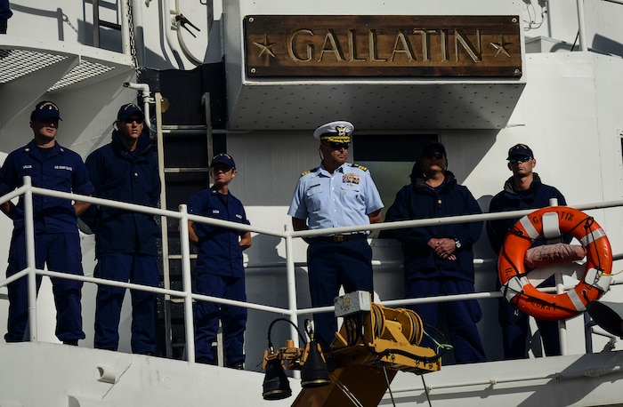USCGC Gallatin’s executive officer, Cmdr. Steve Matadobra (center), and fellow crew members, look for their families and friends as they moor Dec. 11, 2013, in Charleston, S.C. Gallatin’s crew seized more than 1,000 kilos of cocaine with a street value of $34 million during the ship’s final patrol. (U.S. Air Force photo/ Senior Airman Dennis Sloan)