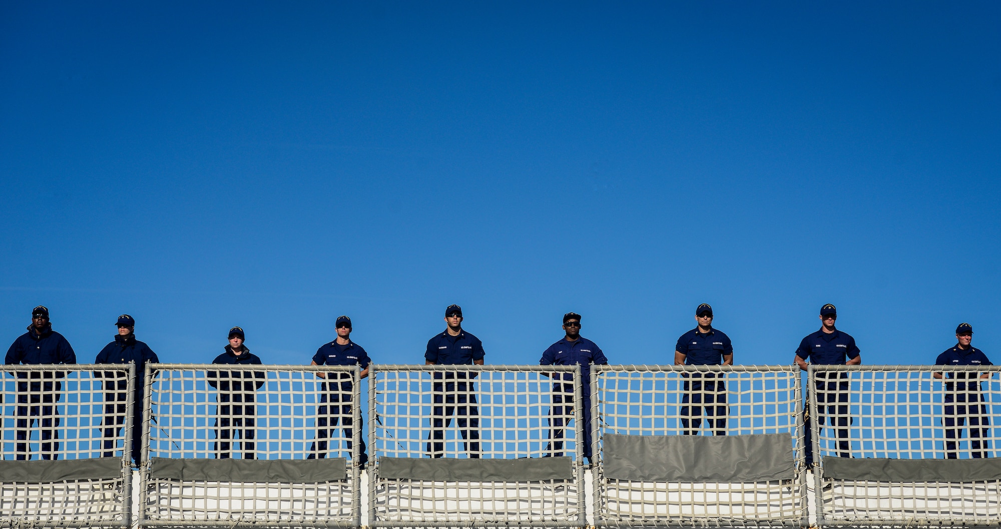 United States Coast Guardsmen stand at parade onboard the national security cutter Gallatin (WHEC 721) as it moors pier side Dec. 11, 2013, in Charleston, S.C. During the ship’s final patrol, Gallatin’s crew seized more than 1,000 kilos of cocaine with a street value of $34 million. (U.S. Air Force photo/ Senior Airman Dennis Sloan)