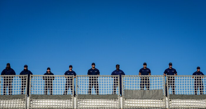 United States Coast Guardsmen stand at parade onboard the national security cutter Gallatin (WHEC 721) as it moors pier side Dec. 11, 2013, in Charleston, S.C. During the ship’s final patrol, Gallatin’s crew seized more than 1,000 kilos of cocaine with a street value of $34 million. (U.S. Air Force photo/ Senior Airman Dennis Sloan)
