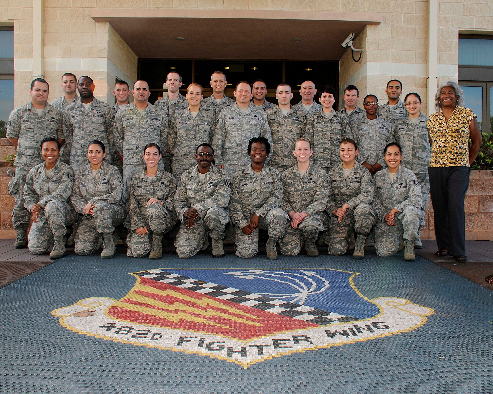 Noncomissioned Officer Leadership Development Course class of Dec. 2013 and Sonja Riley-Glover, NCOLDC civilian instructor, pose on Dec. 10 for a class photo. (U.S. Air Force photo by/Senior Airman Jaimi L. Upthegrove)