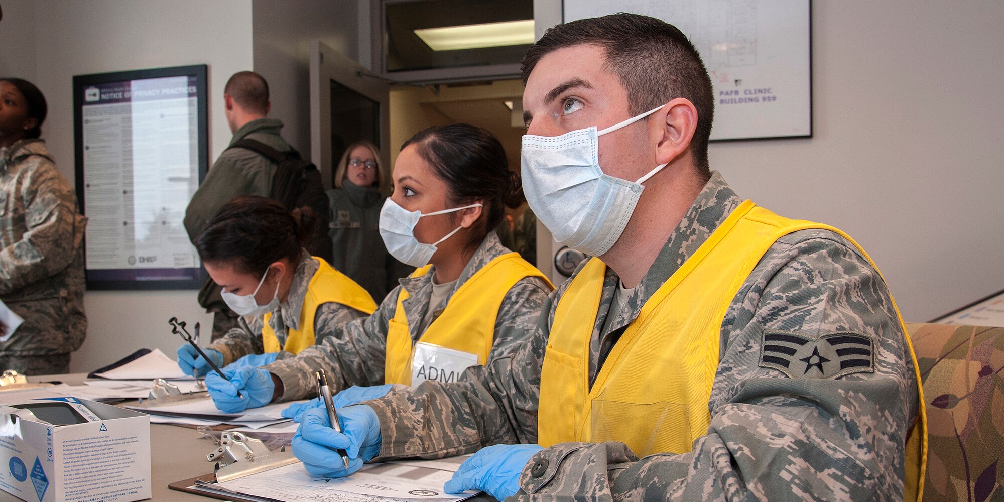 PETERSON AIR FORCE BASE, Colo. -- Senior Airman Nicholas Atherton, 21st Medical Group records technician, collects critical health information from Team Pete personnel to determine if medical treatment is necessary due to an influenza outbreak. During the exercise Dec. 4, a new strain of influenza developed in the Pacific and swept the country. The 21st MDG set up vaccine distribution points at Peterson, Schriever Air Force Base and Cheyenne Mountain Air Force Station, and countered the threat by prioritizing the administration of limited preventive medicine. (U.S. Air Force photo/Craig Denton)