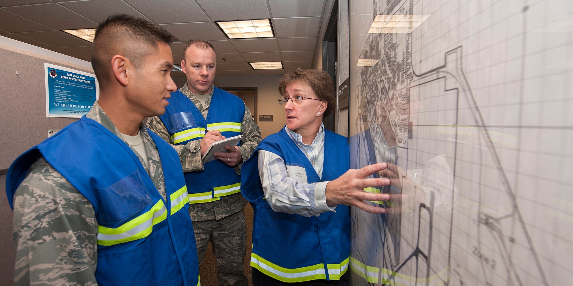 PETERSON AIR FORCE BASE, Colo. -- LJ Van Belkum, 21st Space Wing inspector general (right), discusses an exercise scenario at the 21st Medical Group with Capt. Americo Penaflor, 21st SW inspection director (left) and Master Sgt. Randolph Hodson, inspector general superintendent. The exercise Dec. 4 tested and challenged the 21st MDG and its personnel as they responded to an influenza outbreak. (U.S. Air Force photo/Craig Denton)