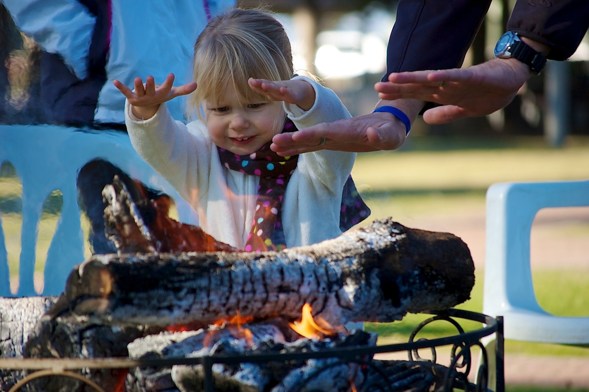 An Incirlik youth holds her hands over a fire pit for warmth during the first ever Winter Fest Dec. 14, 2013, at Incirlik Air Base, Turkey.  The first ever Winter Fest was held by the 39th Force Support Squadron and kept attendees entertained with several activity booths, music from the Incirlik Unit School choir and a play by the Youth Center.  (Courtesy photo by Kristina Liapis)