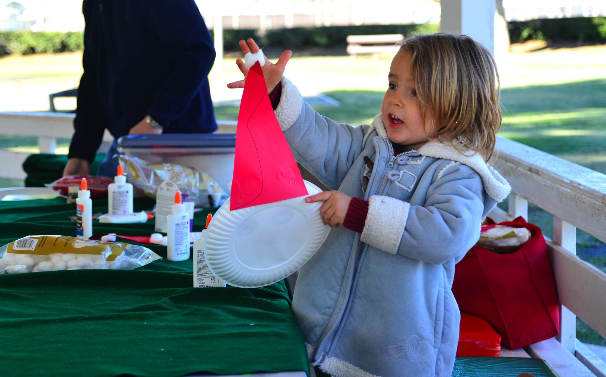 An Incirlik youth plays with a Santa Clause she made at a craft booth during Winter Fest Dec. 14, 2013, at Incirlik Air Base, Turkey. The first ever Winter Fest at Incirlik also featured a play hosted by Incirlik’s Youth Center, singing provided by the Incirlik Unit School choir and a fire pit for attendees to stay warm. (U.S. Air Force photo by Staff Sgt. Eric Summers Jr./Released)