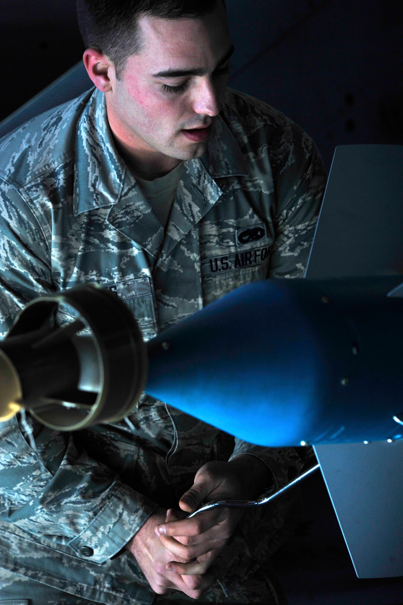 U.S. Air Force Airman 1st Class Russell Voyles, 20th Aircraft Maintenance Squadron, Shooter Aircraft Maintenance Unit weapons load crew member, bolts a fin to a missile on an F-16 Fighting Falcon, Shaw Air Force Base, S.C., Dec. 13, 2013. Voyles prepared the jet along with his crew during the load crew of the quarter competition. (U.S. Air Force photo by Airman 1st Class Jensen Stidham/Released)