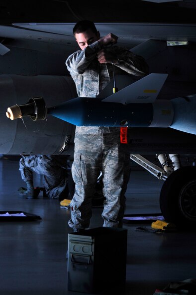 U.S. Air Force Airman 1st Class Russell Voyles, 20th Aircraft Maintenance Squadron, Shooter Aircraft Maintenance Unit weapons load crew member, bolts a fin to a missile on an F-16 Fighting Falcon, Shaw Air Force Base, S.C., Dec. 13, 2013. Voyles along with his crew worked together to load munitions during the fourth quarter load crew competition. (U.S. Air Force photo by Airman 1st Class Jensen Stidham/Released)