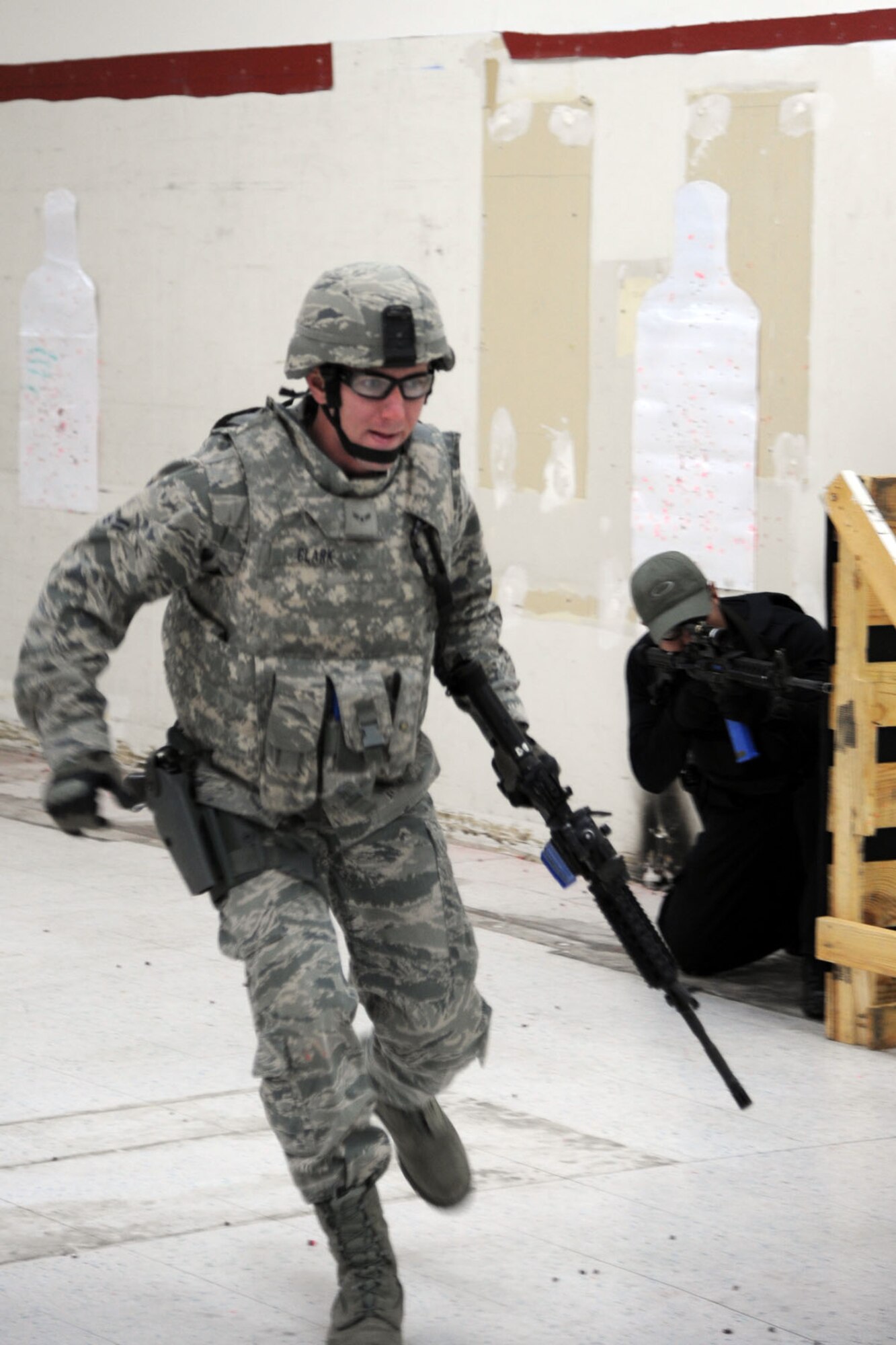 PETERSON AIR FORCE BASE, Colo. – Airman 1st Class Wesley Clark, 21st Security Forces Squadron unit training scheduler, rushes for cover during a Shoot, Move, Communicate course on Peterson AFB Dec. 4. The purpose of the exercise, a standardized Air Force practice, is to prepare security forces members to effectively adapt and respond to one another while reacting to enemy fire, especially in a deployed environment. (U.S. Air Force photo/ Staff Sgt. J. Aaron Breeden)
