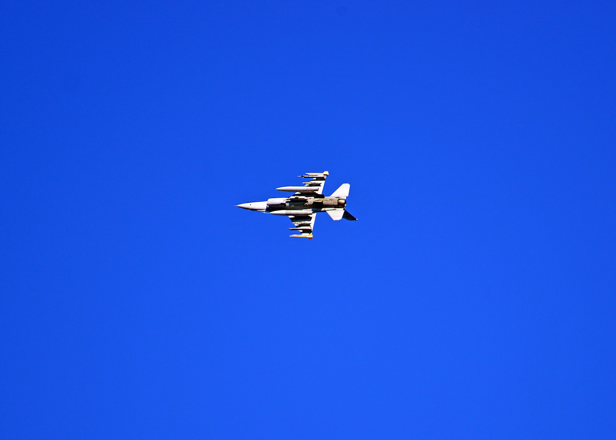 An F-16 Fighting Falcon flies at low altitude during close air support training, Dec. 17, 2013, at Aviano Air Base, Italy. CAS training trains pilots to use military aircraft to deter and eliminate  enemy ground forces that are in close proximity to friendly forces. This requires detailed coordination with ground troops and is typically conducted through joint terminal attack controllers. (U.S. Air Force photo/ Senior Airman Briana Jones)
