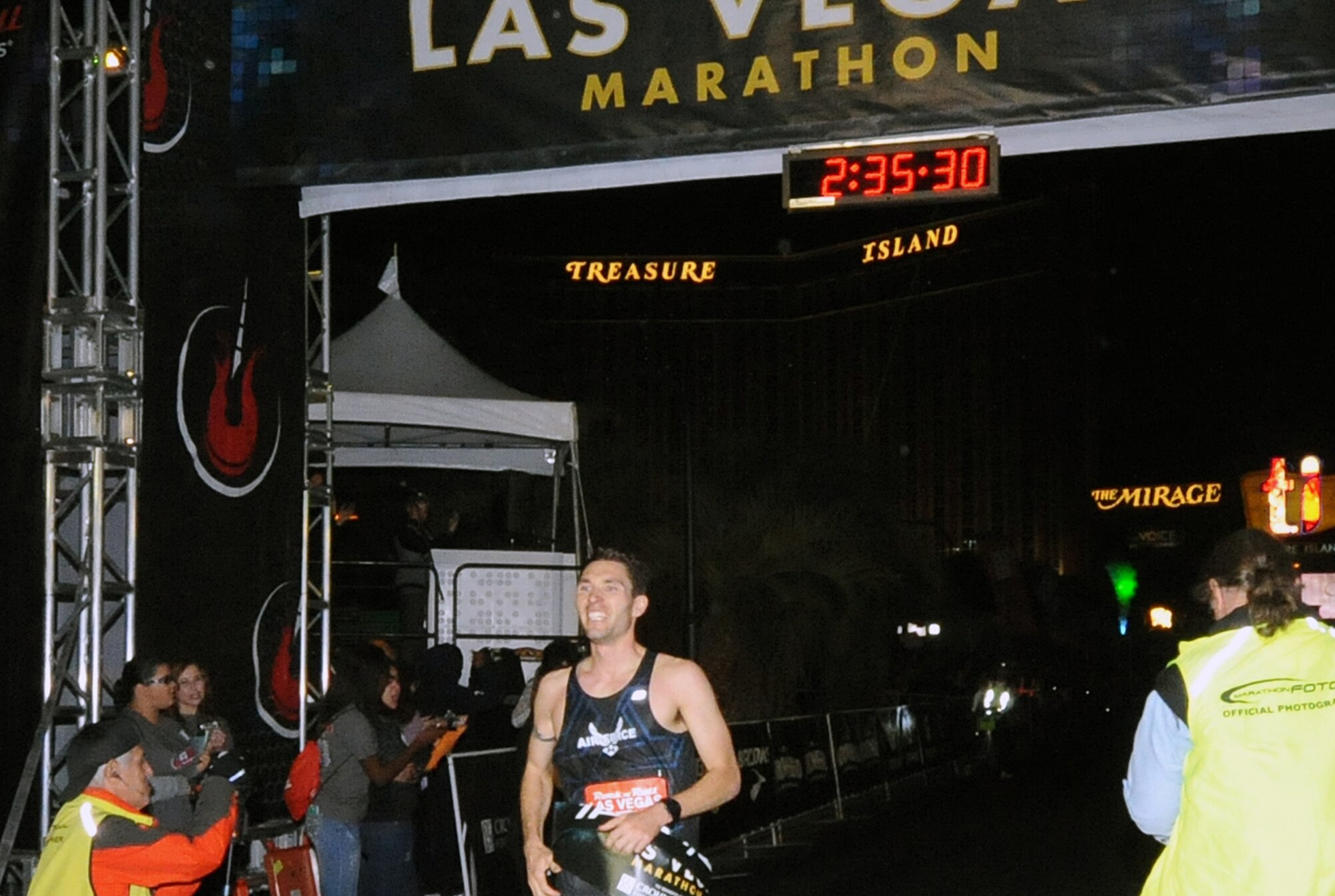 LAS VEGAS, Nev. – Capt. Jason Brosseau, 76th Space Control Squadron crew commander, smiles as he crosses the finish line, clinching first place at the Rock ‘n’ Roll Marathon Series in Las Vegas Nov. 17. Brosseau credited his success to his six months of desert training while deployed to Al Udeid Air Base, Qatar. The hot and dry weather in Qatar allowed Brosseau to acclimate and condition himself for the full marathon in Las Vegas. (Courtesy photo)