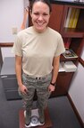 Master Sgt. Danielle Downs, 916th Force Support Squadron unit training manager, weighs-in for the "Biggest Loser" contest at Seymour Johnson Air Force Base in December. (U.S. Air Force photo by Staff Sgt. Terrica Y. Jones, 916th ARW/PA)