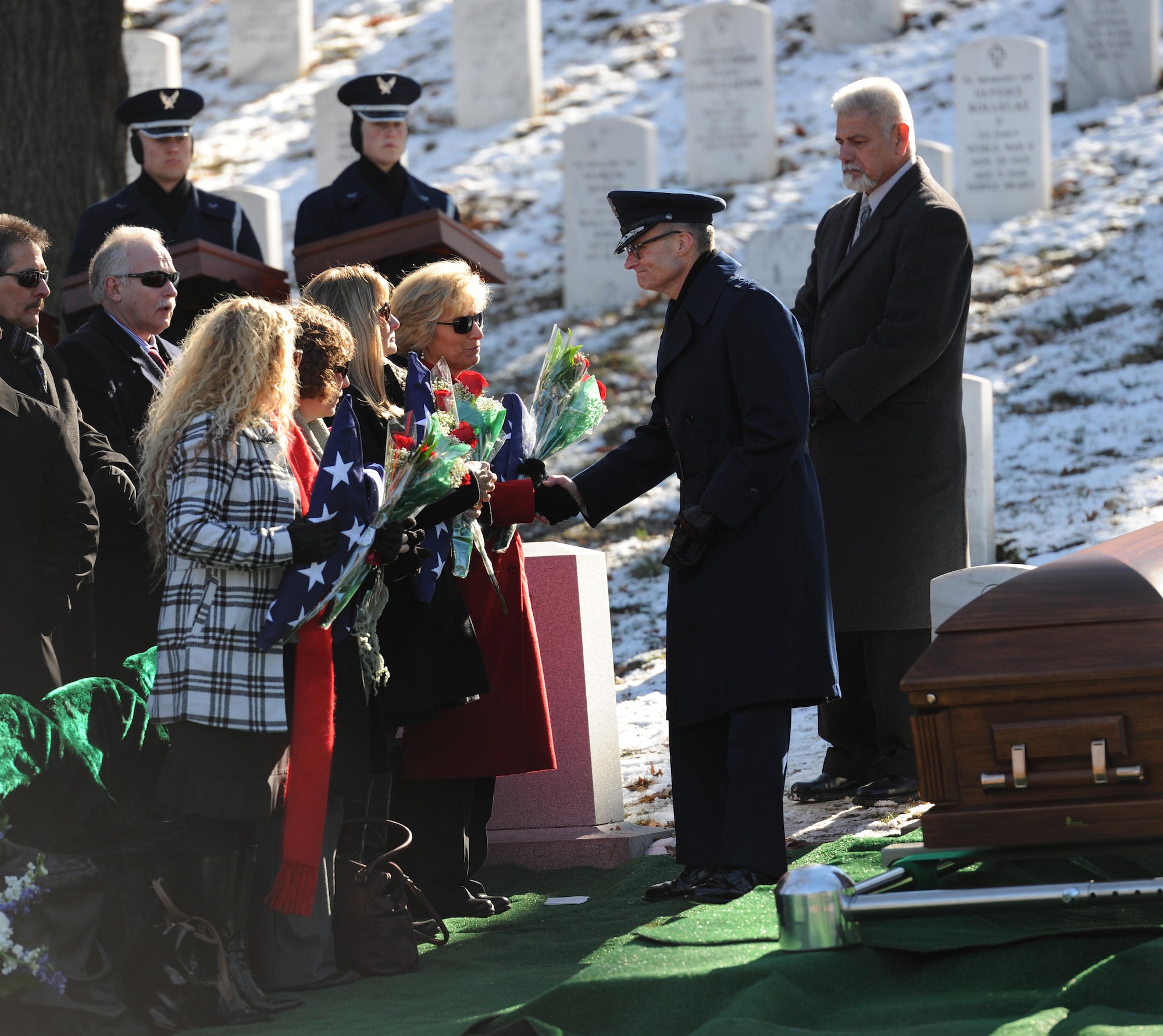 Family and friends of Col. Francis J. McGouldrick Jr. pay tribute to him as he is laid to rest Dec. 13, 2013, at Arlington National Cemetery, Va. McGouldrick was missing in action since 1968 when his plane collided with another plane. His remains were found in a remote jungle in Laos. (U.S. Air Force photo/Airman 1st Class Nesha Humes)
