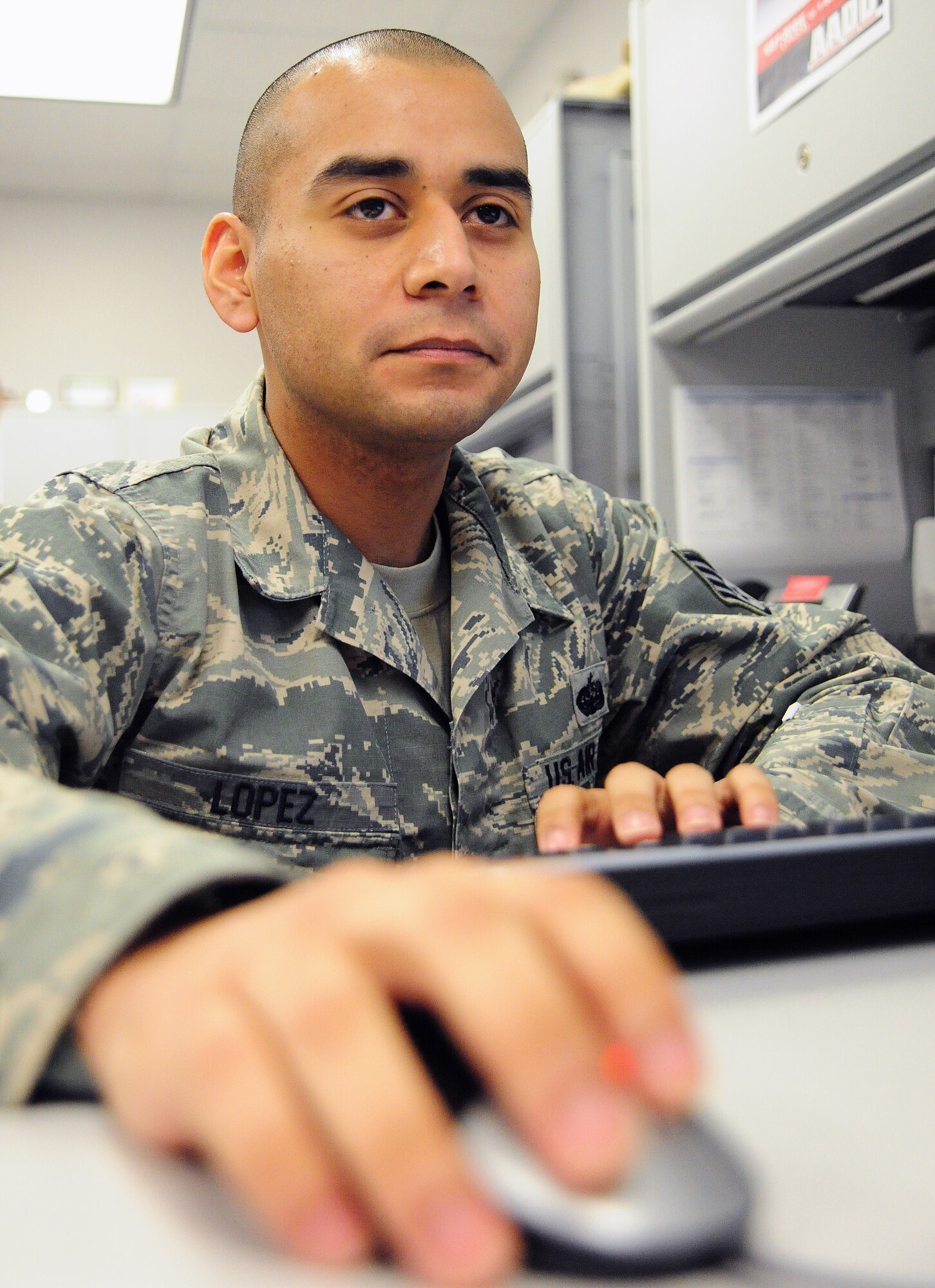 Staff Sgt. Gabriel Lopez, 509th Communications Squadron network technician, looks through a network management server at Whiteman Air Force Base, Mo., Dec. 5, 2013. The network management server provides Lopez a real-time view of every network on base. (U.S. Air Force photo by Staff Sgt. Nick Wilson/Released)