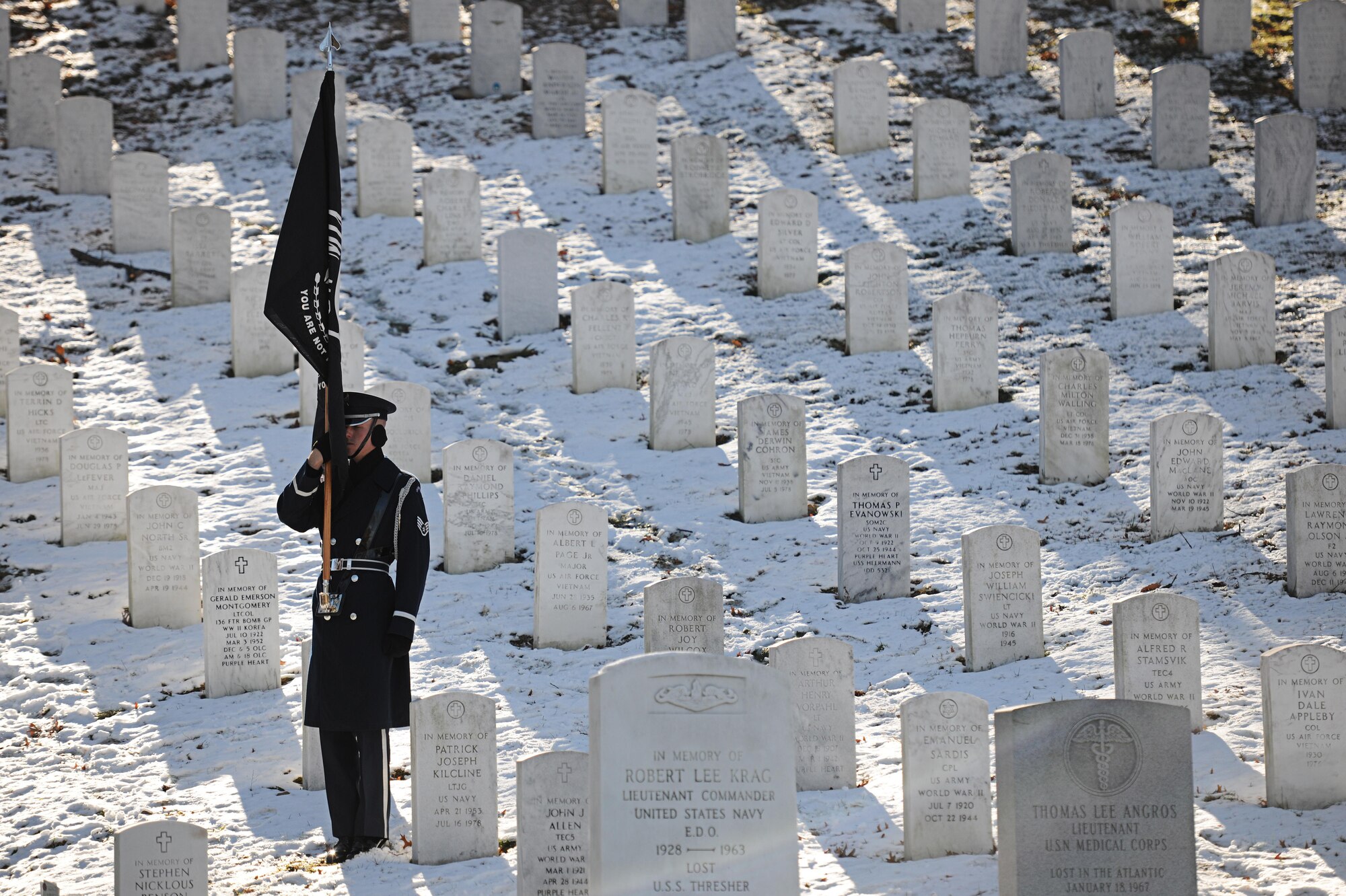 A U.S. Air Force Honor guardsman holds the Prisoner of War Flag during a funeral honoring Col. Francis J. McGouldrick Dec. 13, 2013, at Arlington National Cemetery, Va. McGouldrick was laid to rest after being mission in action for 45 years. McGouldrick’s remains were found in a remote jungle in Laos. (U.S. Air Force photo/Airman 1st Class Nesha Humes)
