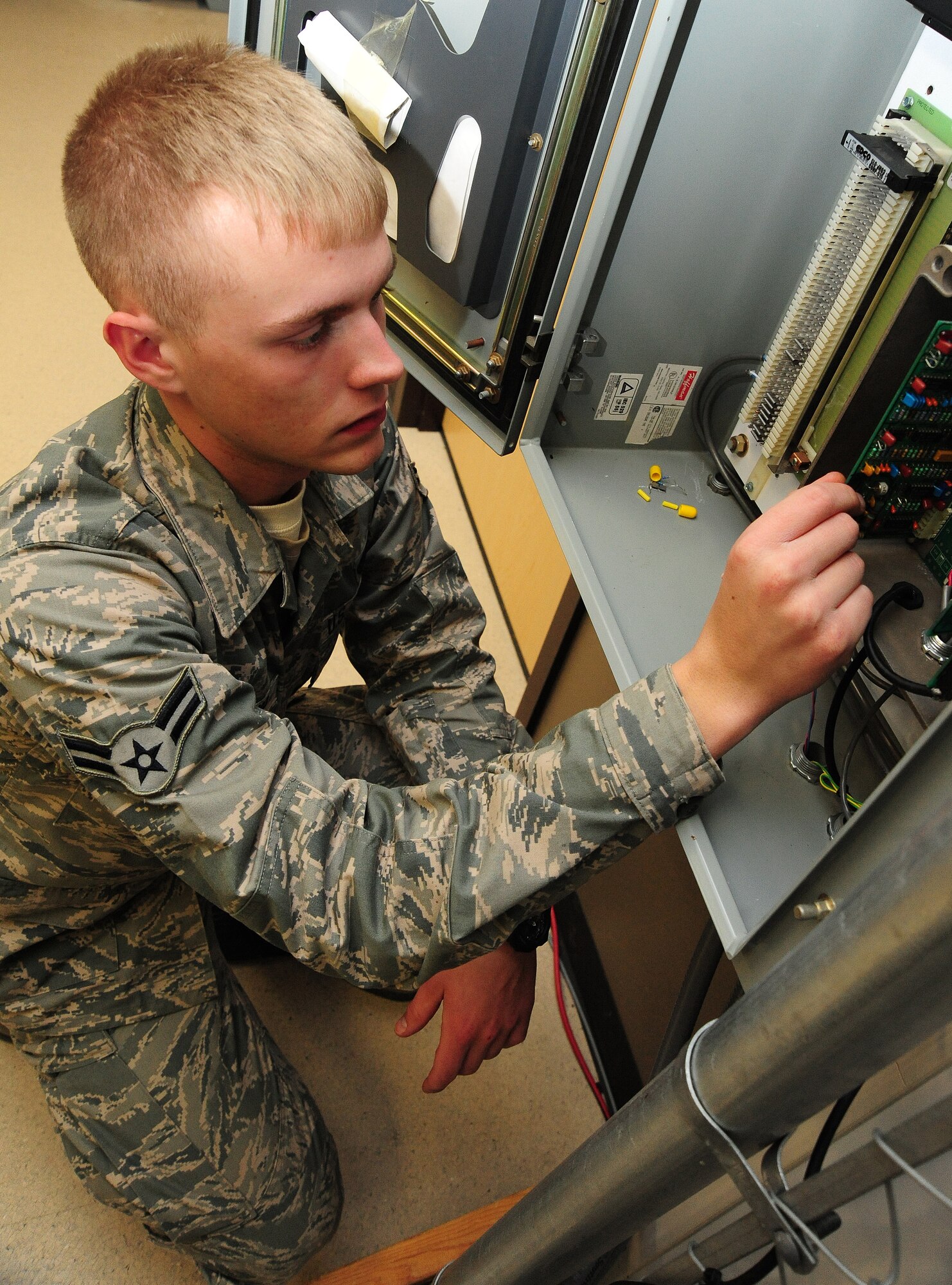 Airman 1st Class Ryan Helmcamp, 509th Communications Squadron intrusion detection systems technician, checks connections on an alarm system at Whiteman Air Force Base, Mo., Dec. 5, 2013. If an alarm system on base goes down, IDS technicians must be able to go out and troubleshoot at a moment’s notice. (U.S. Air Force photo by Staff Sgt. Nick Wilson/Released)