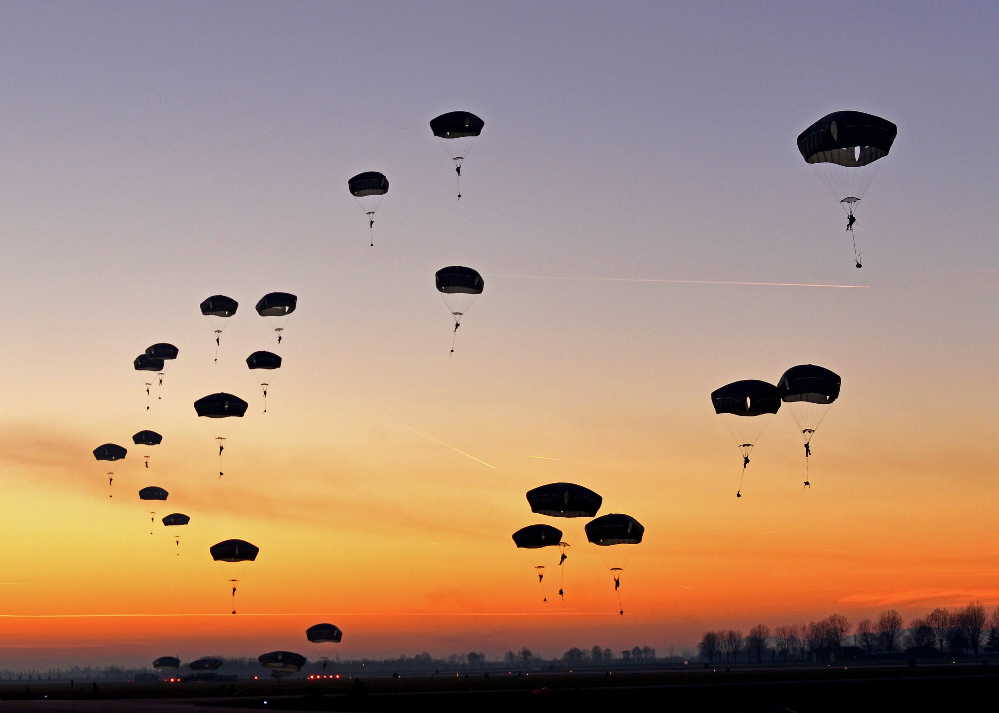Paratroopers from 1st Batallion, 503rd Infantry Regiment and 173rd Airborne Brigade Combat Team, prepare to land after jumping from a C-130 Hercules, Dec. 11, 2013, at Rivolta Italian air force base, Italy.  Airmen from Ramstein Air Base, Germany, and the 31 Fighter Wing, Aviano Air Base, Italy, partnered with soldiers from U.S. Army at Vicenza to conduct airfield seizure training operations during a two week close air support training exercise. (U.S. Air Force photo/Senior Airman Briana Jones)