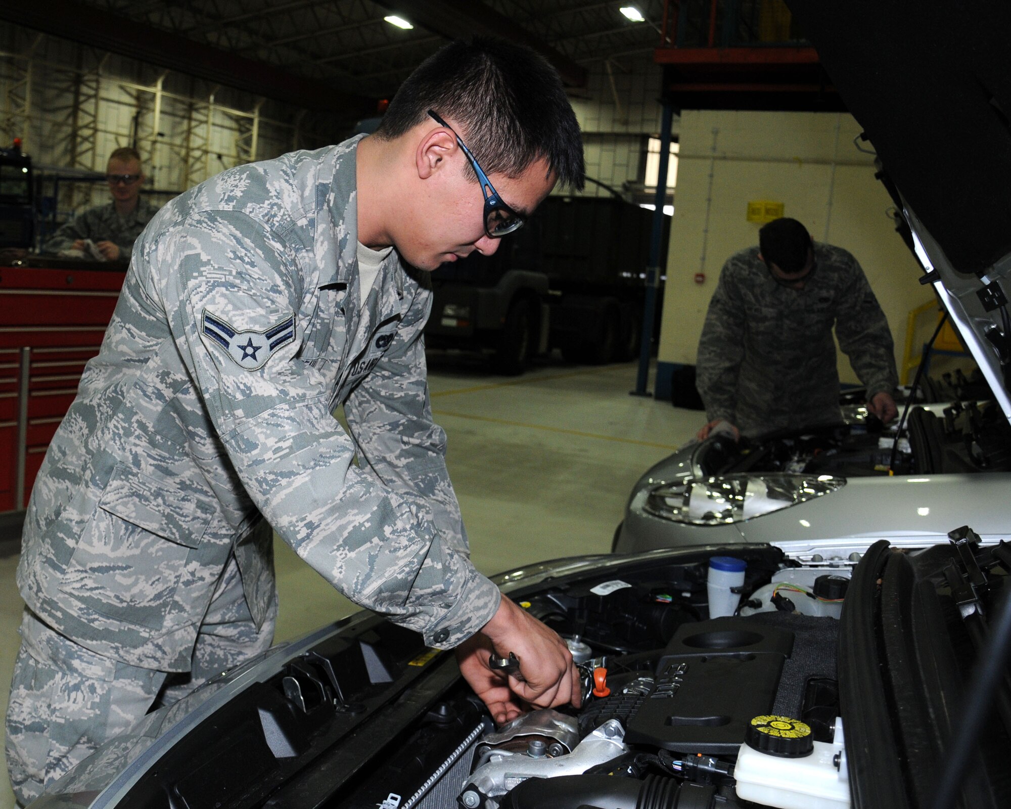 U.S. Air Force Airman 1st Class Jandreau Lance, 100th Logistics Readiness Squadron vehicle maintainer from Caribou, Maine, inspects the oxygen sensor of the engine of a newly assigned low-carbon, fuel-efficient diesel sedan Dec. 6, 2013, on RAF Mildenhall, England. The 100th LRS have replaced 19 vehicles with a newer more environmentally friendly fleet. The miles per gallon on the new vehicles average around 60 mpg as opposed to 15 mpg on the previous cars. The new vehicles arrived between September and October 2013. (U.S. Air Force photo by Gina Randall/Released) 