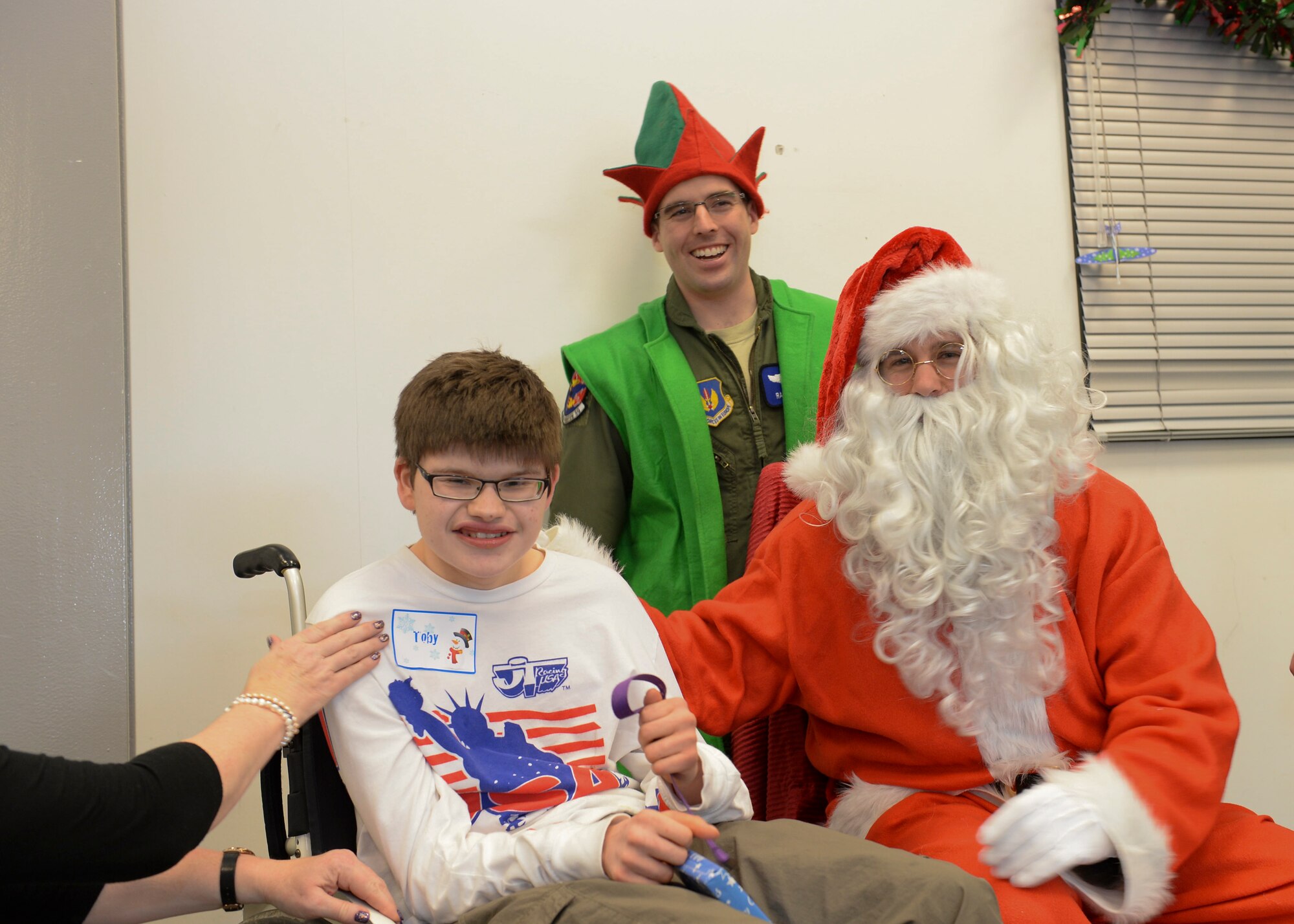 Santa gives a present to Toby Marriott, 15, during the Duxford Christmas party at the Imperial War Museum Dec. 14, 2013. Established during World War II, the Duxford Christmas party was created by the Royal Air Force Duxford 78th Fighter Group to supply gifts and support to children from the London area who were orphaned by the war. (U.S Air Force photo by Airman 1st Class Nigel Sandridge/ Released)