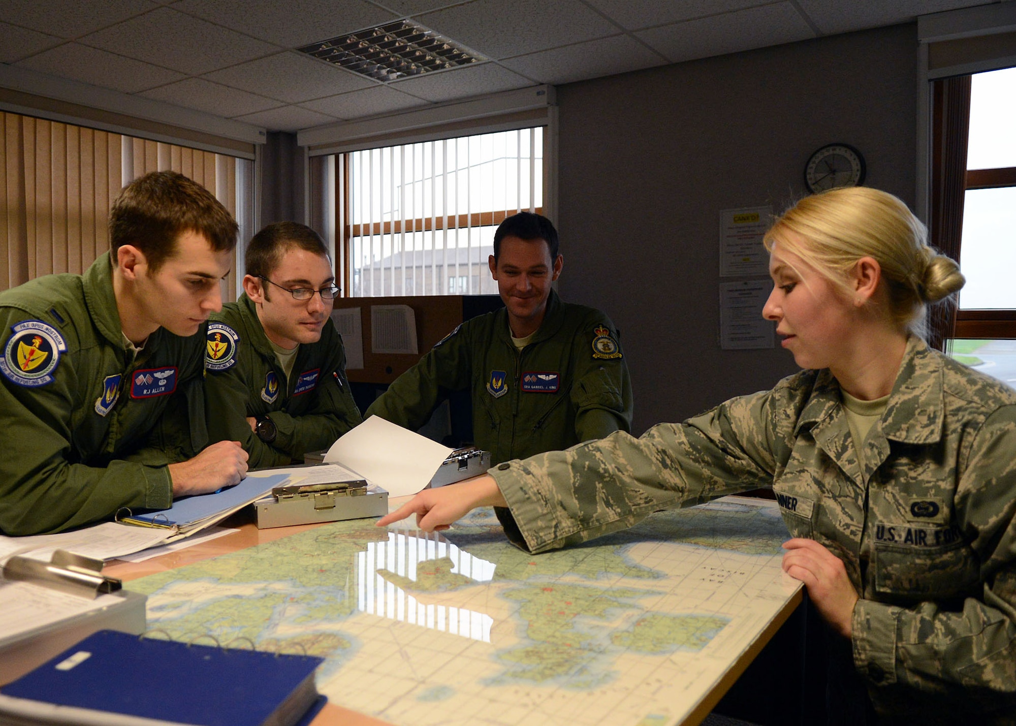 U.S. Air Force Senior Airman Christiane M. Tanner, 100th Operations Group external intelligence training analyst from Lacey, Wash., gives a pre-mission brief to aircrew members Dec 13, 2013, on RAF Mildenhall, England. Tanner was selected for the spotlight for exhibiting the Air Force Core Value — Excellence in All We Do. (U.S. Air Force photo by Airman 1st Class Kyla Gifford/Released) 