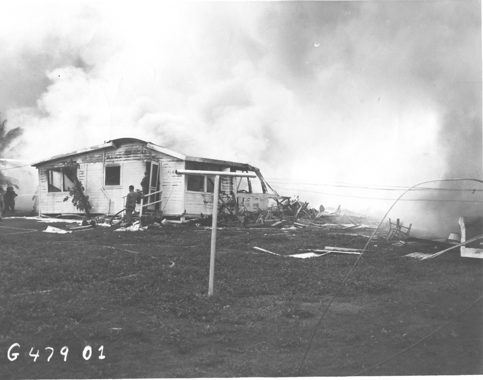 Lt Col. Benjamin L. Mills’ home burns after a B-29 Liberator crashed into it on Andersen Air Force Base, Guam Dec. 17, Mills, the 3rd Aviation Field Depot Squadron commander, his wife Agnes, and three daughters Margaret, Helen, and Martha were all killed in the crash. (U.S. Air Force phot/Released)