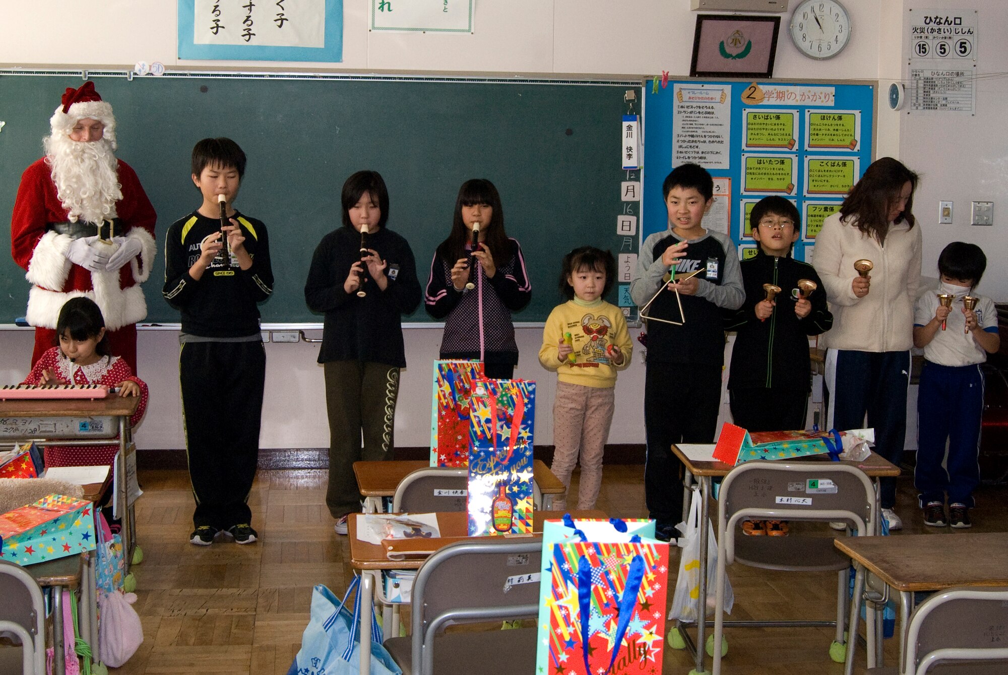 Santa Claus listens as students from Kamikubo Shougaltuko Elementary School
perform a song called "Edelweiss" during a visit Dec. 16, 2013, in Misawa City, Japan. Edelweiss is a song from the musical "The Sound of Music" and is named after
a flower of the same name. The visit allowed the members of Misawa Air Base to expand relationships between the American and Japanese communities. (Courtesy
Photo)
