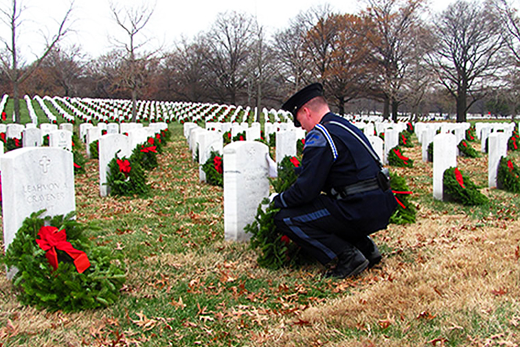 Kevin Haley, Police Officer from Portland, Maine, pauses as he lays a