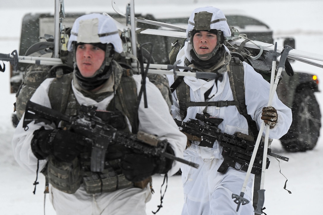 Army Sgt. Matthew Berg, left, and Army Spc. William Baker, march to a ...