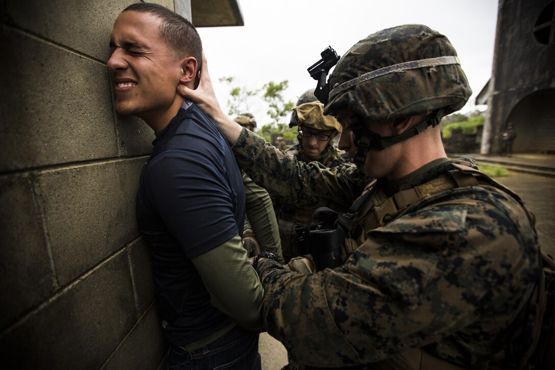 A Marine with Combat Logistics Battalion 31, 31st Marine Expeditionary Unit, detains a roleplaying aggressor during a mass casualty evacuation drill here, Dec. 13. The drill was part of the 31st MEU's pre-deployment training package which refreshes the unit's subordinate commands in a variety of operational capabilities. The 31st MEU is the Marine Corps' force in readiness in the Asia-Pacific region and is the only continually forward-deployed MEU.