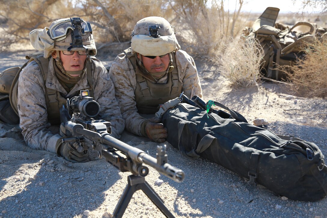 Private First Class Christopher Carlson, machine gunner, 1st Battalion, 5th Marine Regiment, and Pfc. Ivan Martinez, team leader, 1st Bn, 5th Marines, post security during a helicopter raid in support of Exercise Steel Knight 2014 at Marine Corps Air Ground Combat Center Twentynine Palms, Calif., Dec 11th, 2013. The training developed important skills and tactics necessary for their upcoming deployment to Australia. Steel Knight is an annual exercise that includes elements from the entire I Marine Expeditionary Force that focuses on conventional operations and provides realistic training that prepares Marines for overseas operations. (U.S Marine Corps photo by Lance Cpl. Jonathan Boynes/Released)