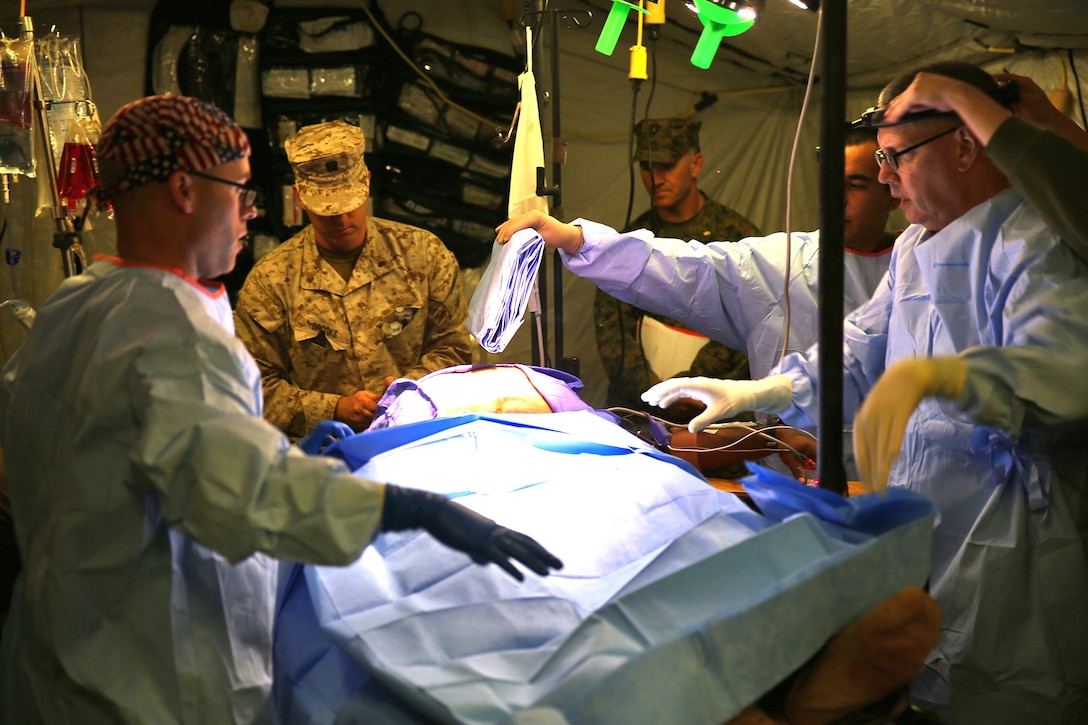 Sailors with Alpha Surgical Company, 1st Medical Battalion, 1st Marine Logistics Group, prepare to operate on simulated patient during a mass casualty drill aboard Camp Pendleton, Calif., Dec. 10, 2013. The drill was part of the unit’s pre-deployment training in preparation for an upcoming deployment to Afghanistan with Combat Logistics Battalion 7. Many of the casualties wore a cut suit with simulated organs and arteries which provide realistic training to corpsmen and surgeons.