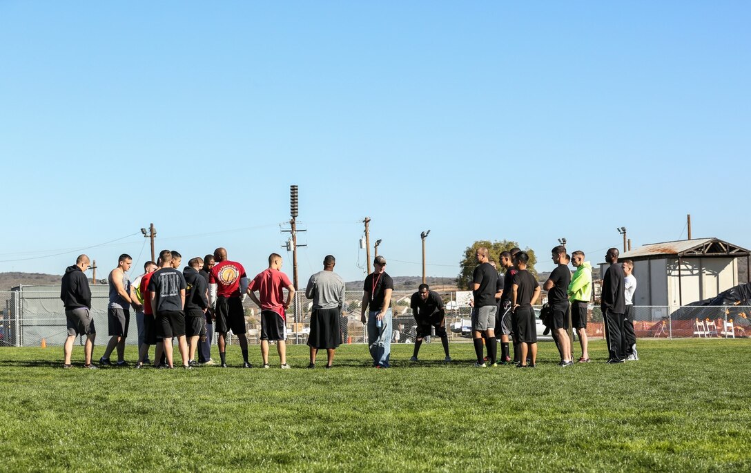 Marines and sailors with the 15th Marine Expeditionary Unit and Combat Logistics Battalion 15 meet on the grid iron for a football game aboard Camp Pendleton, Calif., Dec. 13. The 15th MEU played to promote esprit de corps and camaraderie between both units. (U.S. Marine Corps photo by Cpl. Emmanuel Ramos/Released)