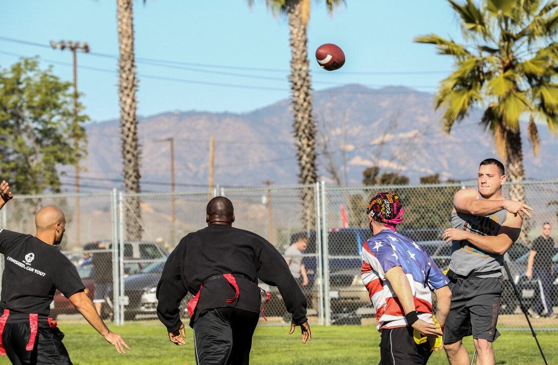 Marines and sailors with 15th Marine Expeditionary Unit and Combat Logistics Battalion 15 play football aboard Camp Pendleton, Calif., Dec. 13. The 15th MEU played to promote esprit de corps and camaraderie between both units. (U.S. Marine Corps photo by Cpl. Emmanuel Ramos/Released)