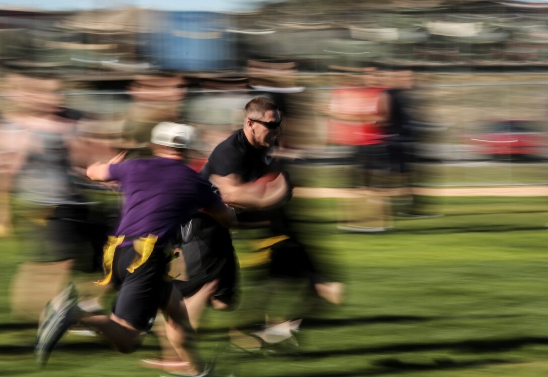 Sergeant Roberto Brown, supply chief, 15th Marine Expeditionary Unit, breaks a tackle during a football game against Combat Logistics Battalion 15 aboard Camp Pendleton, Calif., Dec. 13. The 15th MEU played to promote esprit de corps and camaraderie between both units. Brown, 30, is from Miami. (U.S. Marine Corps photo by Cpl. Emmanuel Ramos/Released)