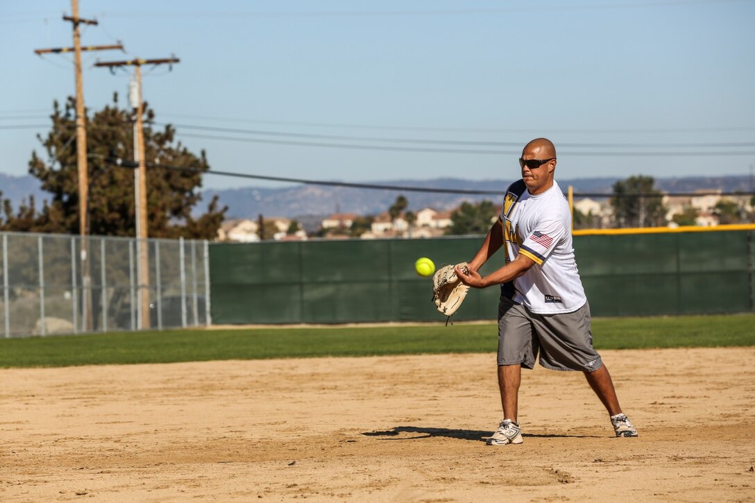 Petty Officer 2nd Class Gabriel Cisneros, religious program, 15th Marine Expeditionary Unit, throws a strike during a softball game against Combat Logistics Battalion 15 aboard Camp Pendleton, Calif., Dec. 13. The 15th MEU played to promote esprit de corps and camaraderie between both units. Cisneros, 36, is from Diamondbar, Calif. (U.S. Marine Corps photo by Cpl. Emmanuel Ramos/Released)