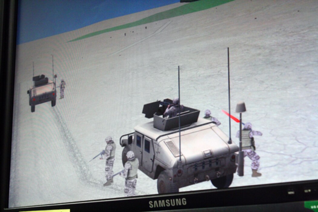 A battle scenario unfolds on the video screen in the combat convoy simulator at Camp Wilson.