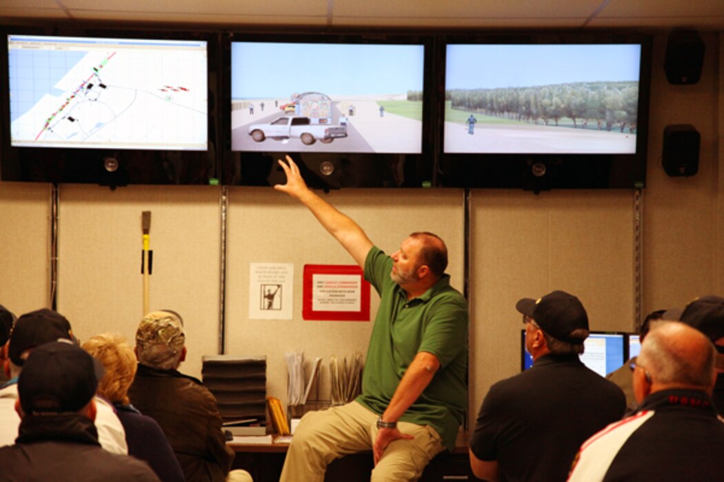 Tour guide Michael King explains to tour participants how instructors create combat convoy scenarios at the Battle Simulation Center at Camp Wilson.