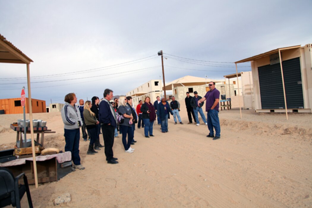 Tour guide Mike King explains to visitors how different training scenerios can unfold in MOUT — Military Operations in Urban Terrain — facilities like the Combat Center's Range 215.