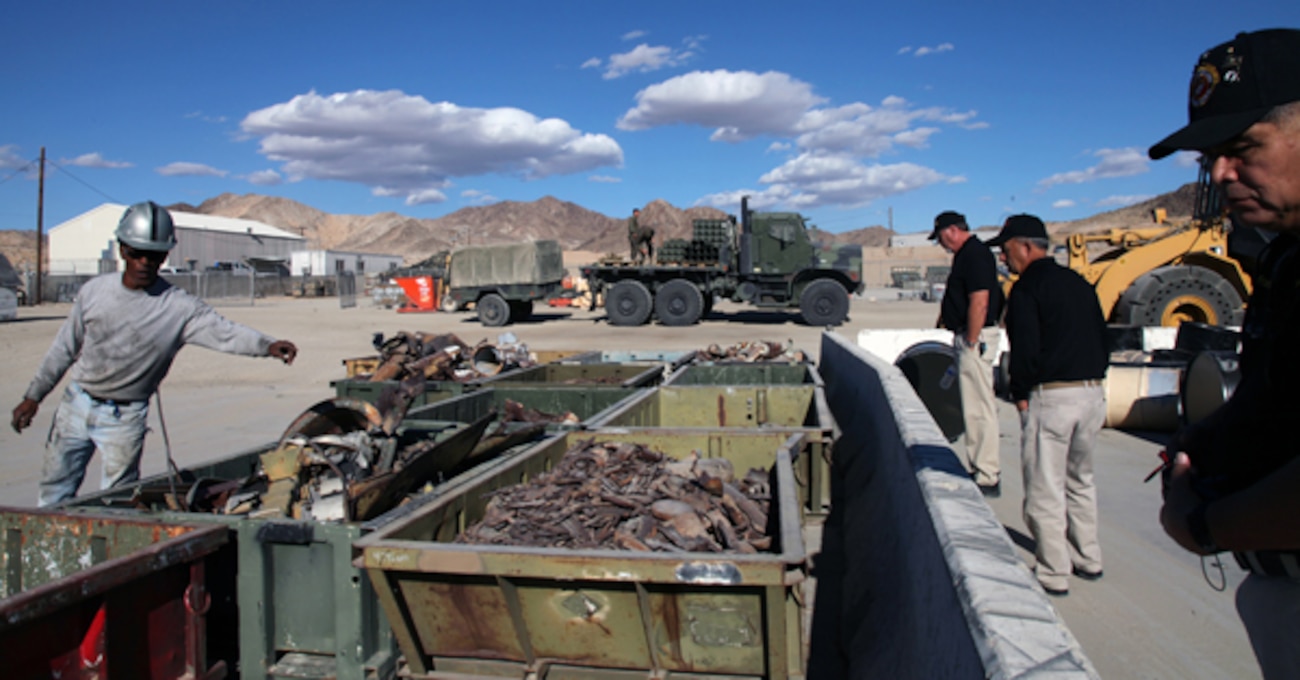 Jay Jones, left, work leader at the Range Sustainment Branch, explains to tour participants how the Combat Center recycles items collected from the installation's live-fire training ranges.
