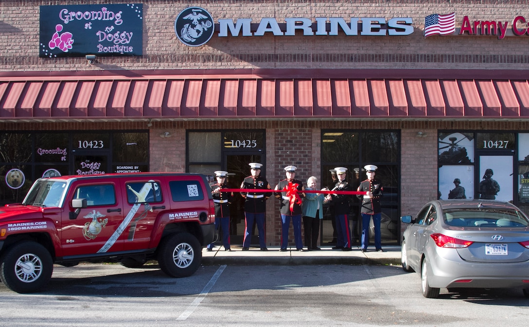 Marines with Marine Corps Recruiting Station Raleigh hold a ribbon with Vivian Jones, the Mayor of Wake Forest, N.C., during a ribbon cutting ceremony at Permanent Contact Station Wake Forest on Dec. 16, 2013. The Marines held a grand opening featuring a ribbon cutting and Toys for Tots drive to promote the new station. (U.S. Marine Corps photo by Sgt. Dwight A. Henderson/Released) 