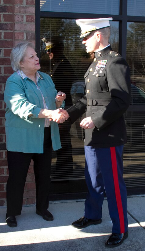 Marine Corps Maj. Brandon J. Gorman, the commanding officer of Marine Corps Recruiting Station Raleigh and Charlotte, N.C., native, presents Vivian Jones, the Mayor of Wake Forest, N.C., with a coin following the Permanent Contact Station Wake Forest grand opening ceremony in Wake Forest, N.C., on Dec. 16, 2013. The Marines held a grand opening featuring a ribbon cutting and Toys for Tots drive to promote the new station. (U.S. Marine Corps photo by Sgt. Dwight A. Henderson/Released) 